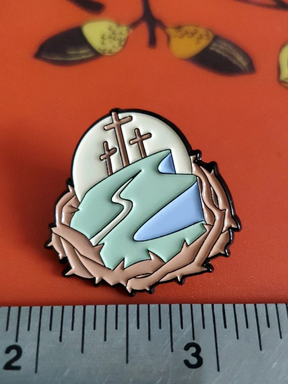 Enamel Pin Featuring Three Crosses and River
